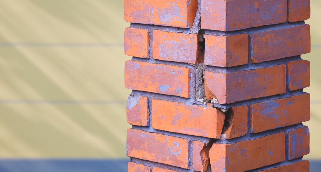 A cracked brick chimney column that needs repair in Anderson, IN