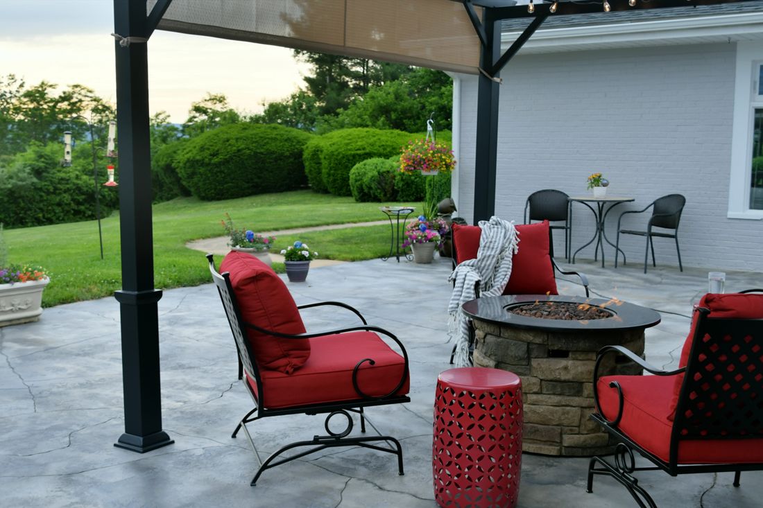 Backyard stone patio with fire pit in Anderson, IN
